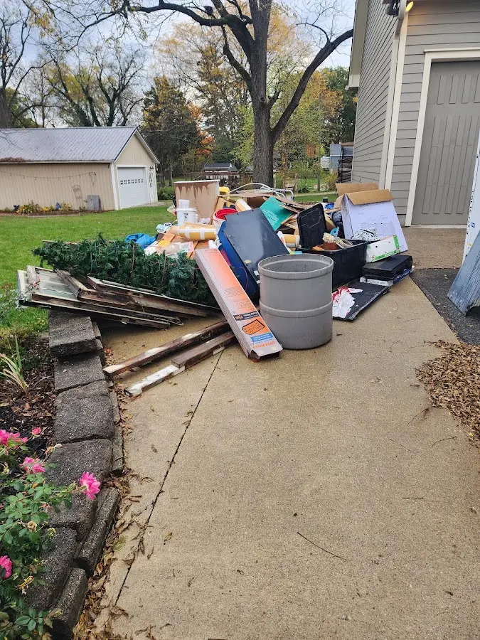 Dumpster being loaded with debris for 12 Yard Dumpster Rental in Linton Hall